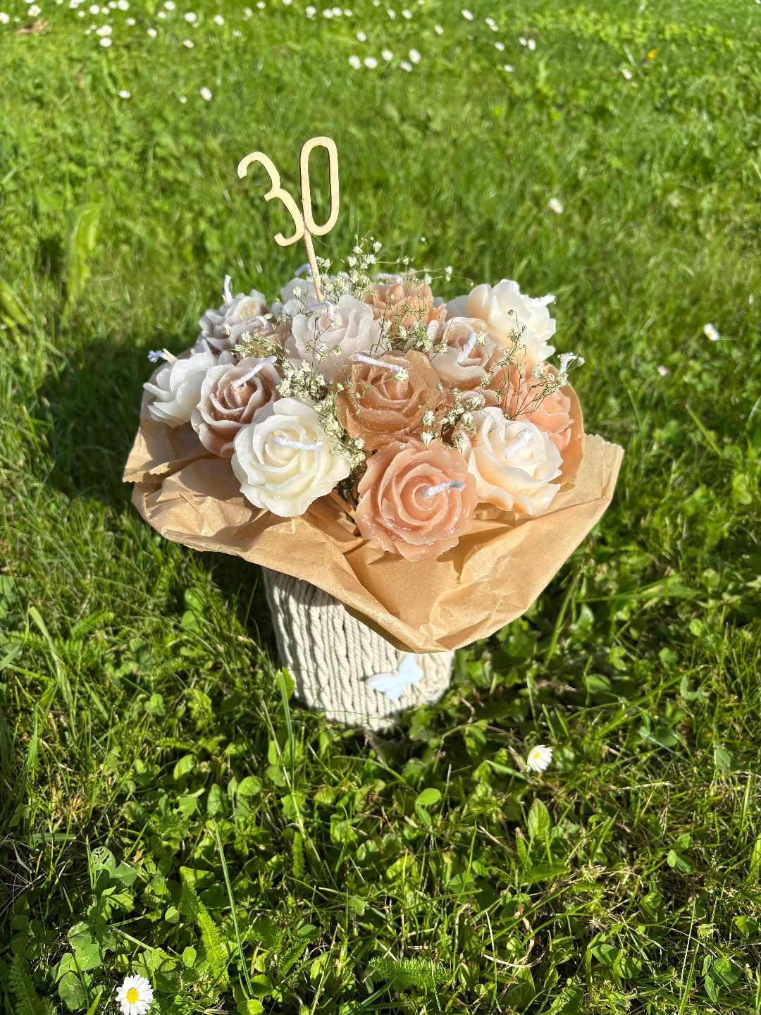 Kerzen, die gemeinsam aussehen wie ein Blumenstrauß aus braun, rosa und weiße Blumenkerzen
