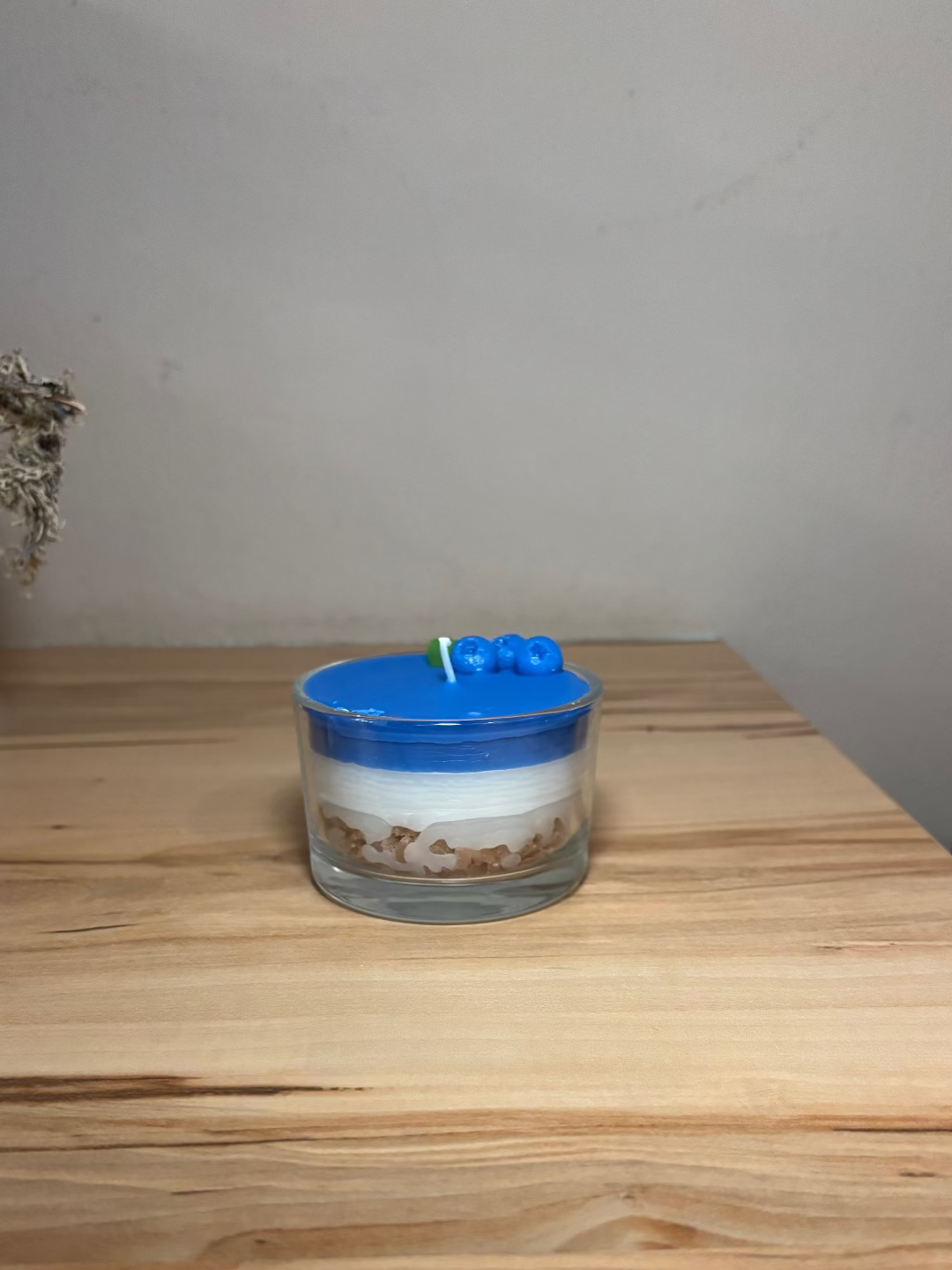 Kerze in einem Glas, das aussieht wie eine Heidelbeertorte